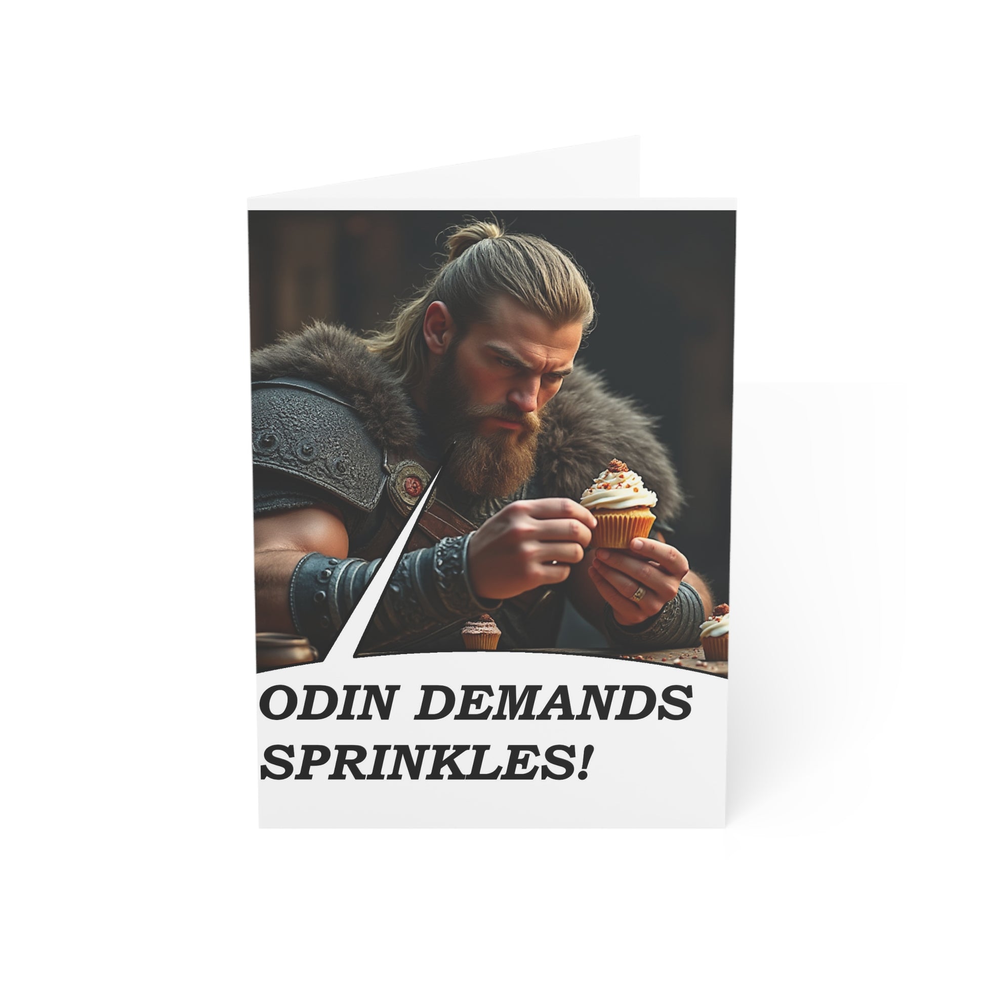 Card with a Viking holding a cupcake and text 'Odin Demands Sprinkles!' on a white background